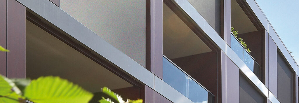 Modern building with glass windows and balconies.