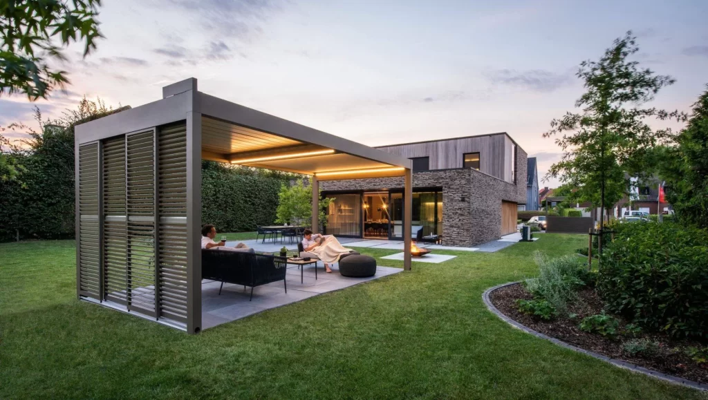 Modern house with stone and wood exterior, large windows.