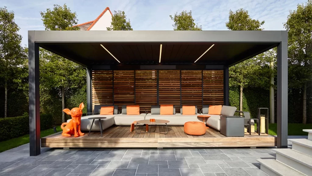 Outdoor patio with pergola, sofas, coffee table, lanterns, and dog sculpture.